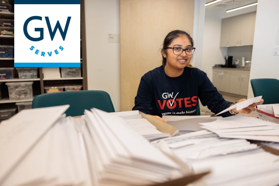GW student Vidya Muthupillai sorts out letters to mail to swing state voters encouraging them to participate in upcoming elections. (William Atkins/GW Today)