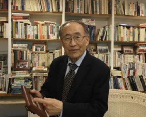 headshot of Young C. Kim in library