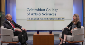 Dean Paul Wahlbeck seated on a stage across from Kimberly Morgan, with a Columbian College logo behind them